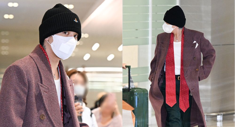 G-Dragon stuns at the airport in a burgundy long coat as he returns from overseas and prepares for his world tour encores